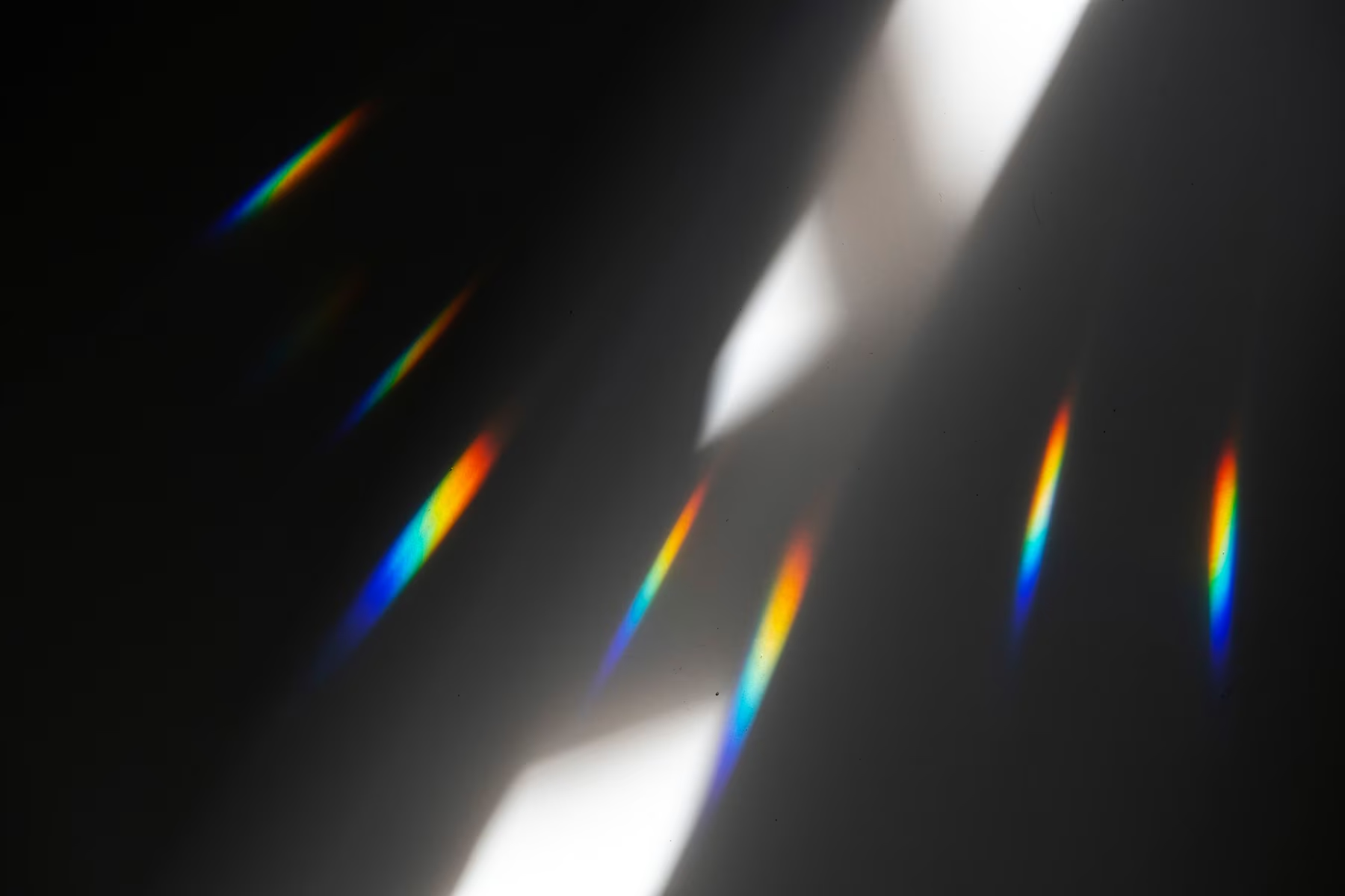 A sheet of bent glass bending and splitting the light passing through it.